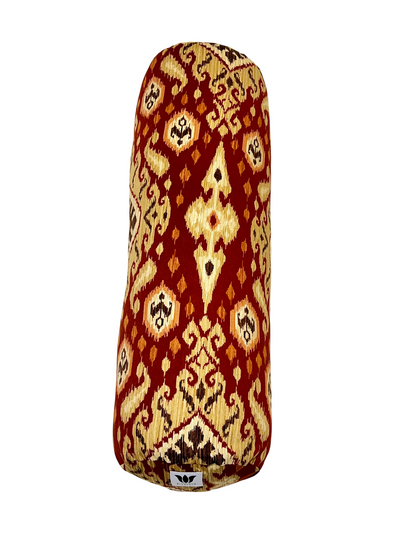 Round yoga bolster in Red and Gold Ikat Print. Cotton canvas removeable cover. Handcrafted in Calgary Alberta Canada