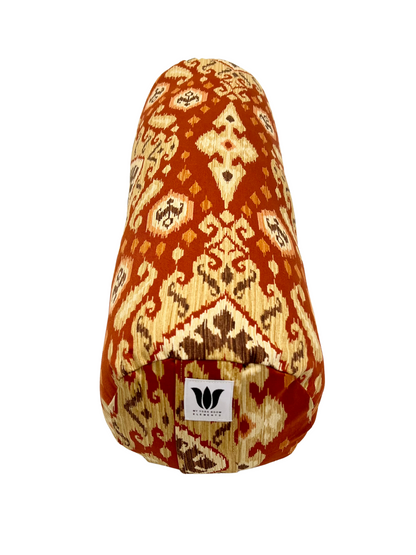 Round yoga bolster in Red and Gold Ikat Print. Cotton canvas removeable cover. Handcrafted in Calgary Alberta Canada