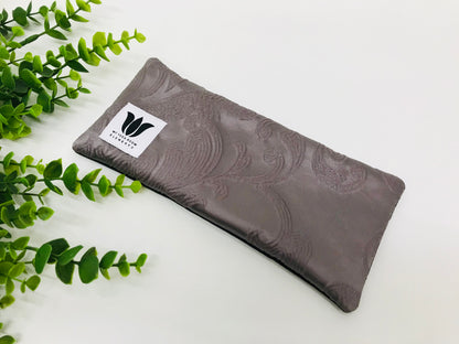 Yoga eye pillow, unscented, therapeutically weighted to soothe eye strain and stress or enhance your savasana. Handcrafted in Canada by My Yoga Room Elements. Purple embossed satin print and bamboo fabric.