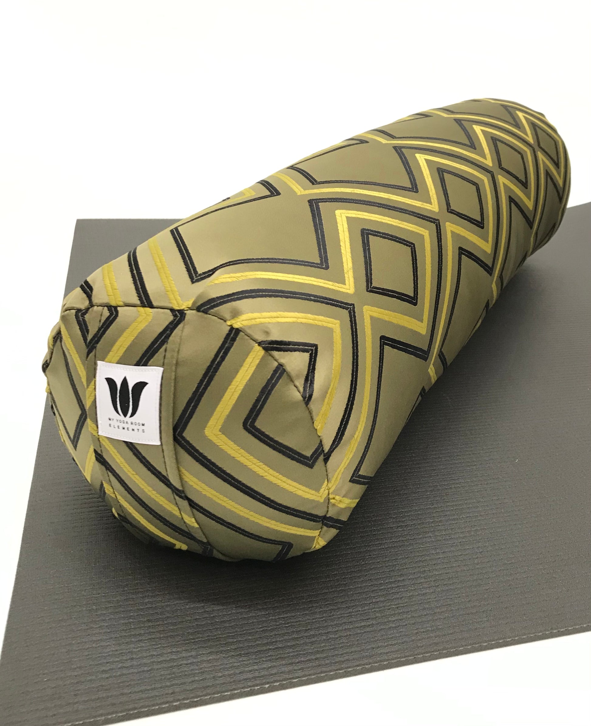 Round yoga bolster in raised embroidered modern diamond print in sage green blue and yellow print fabric. Allergy conscious fill with removeable cover. Made in Canada by My Yoga Room Elements