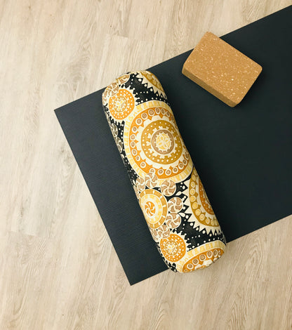 Round yoga bolster in durable cotton canvas, in black and bright colour novelty print fabric. Allergy conscious fill with removeable cover. Made in Canada by My Yoga Room Elements