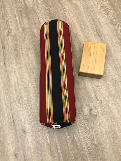 Round yoga bolster in cotton canvas, strip fabric in black, red, beige and gold fabric. Allergy conscious fill with removeable cover. Made in Canada by My Yoga Room Elements